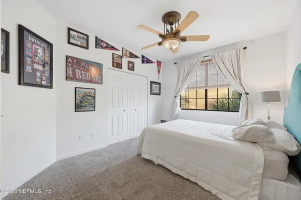 a bedroom with a large bed and a chandelier