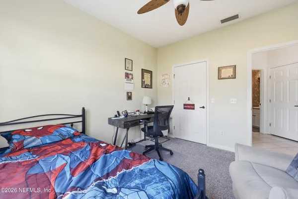 a bedroom with a bed and a table in it