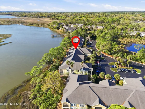 an aerial view of a house with a lake view