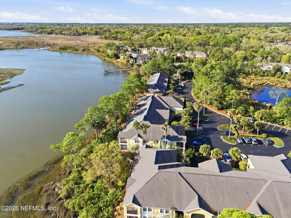 an aerial view of lake and residential houses with outdoor space