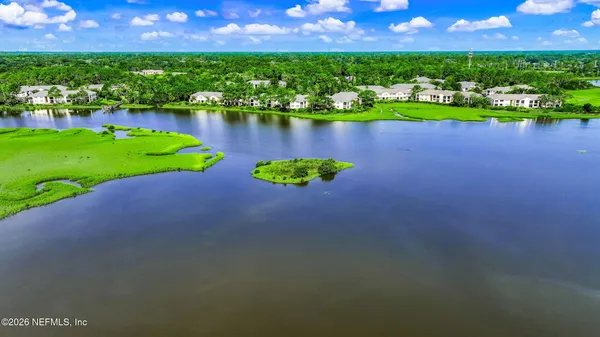 an aerial view of a house with a lake view