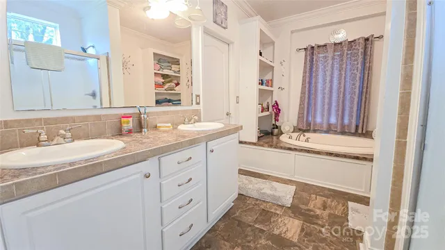 a bathroom with a double vanity sink and a mirror