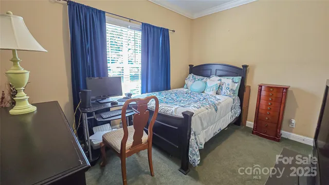 a bedroom with a bed chair and window