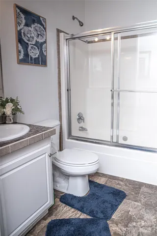 a bathroom with a toilet a sink and a shower