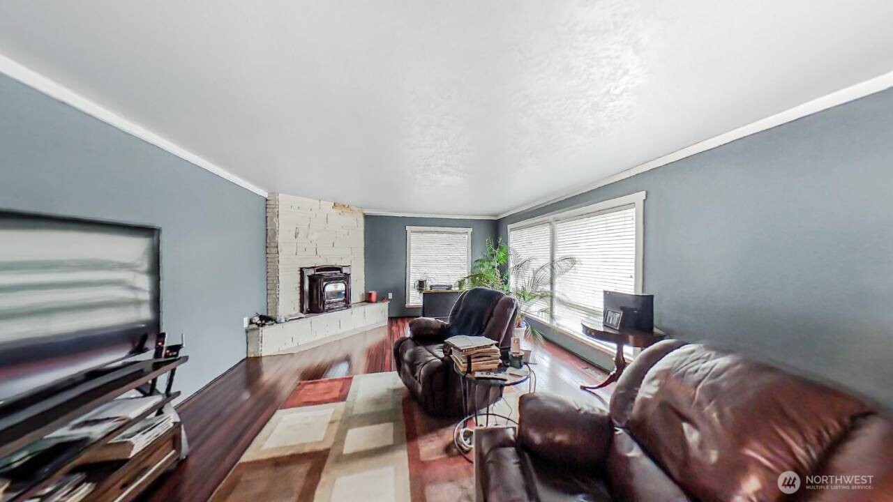 283 Division Avenue Morton, WA 98356 - Photo 5 of 12 a living room with furniture fireplace and a large window