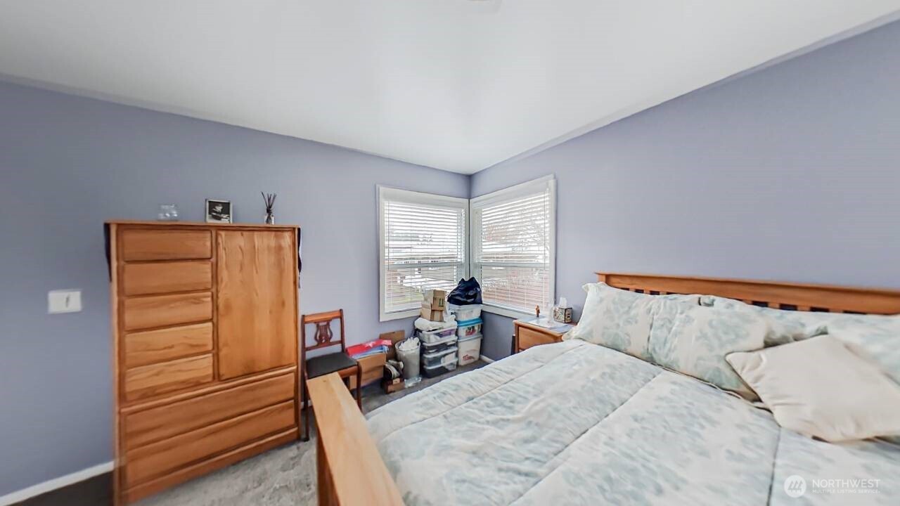 283 Division Avenue Morton, WA 98356 - Photo 7 of 12 a bedroom with a bed and furniture