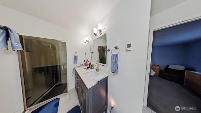 a bathroom with a sink a mirror and a shower