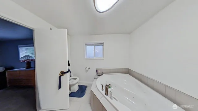 a bathroom with a tub and a toilet