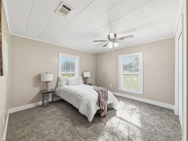 a spacious bedroom with a bed and a window