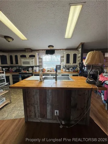 a kitchen with stainless steel appliances a stove a sink dishwasher and cabinets