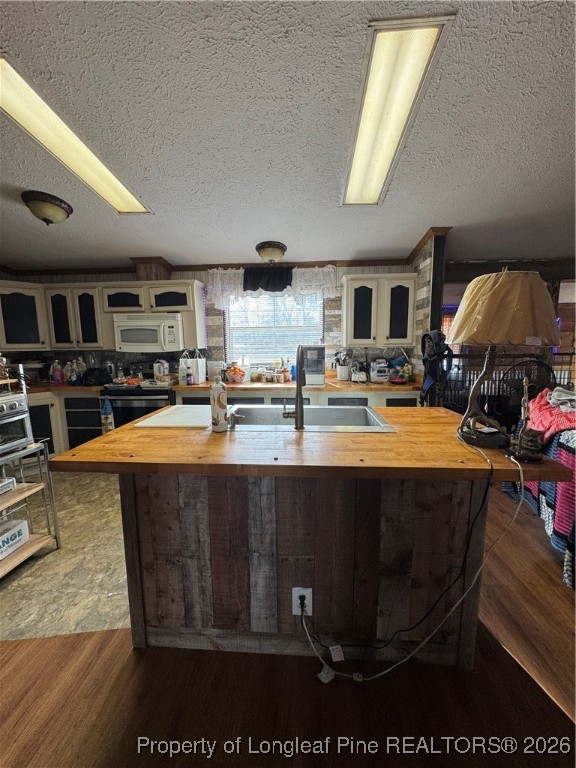 5306 Temperance Hall Road Elm City, NC 27822 - Photo 5 of 22 a kitchen with stainless steel appliances granite countertop a stove refrigerator and cabinets