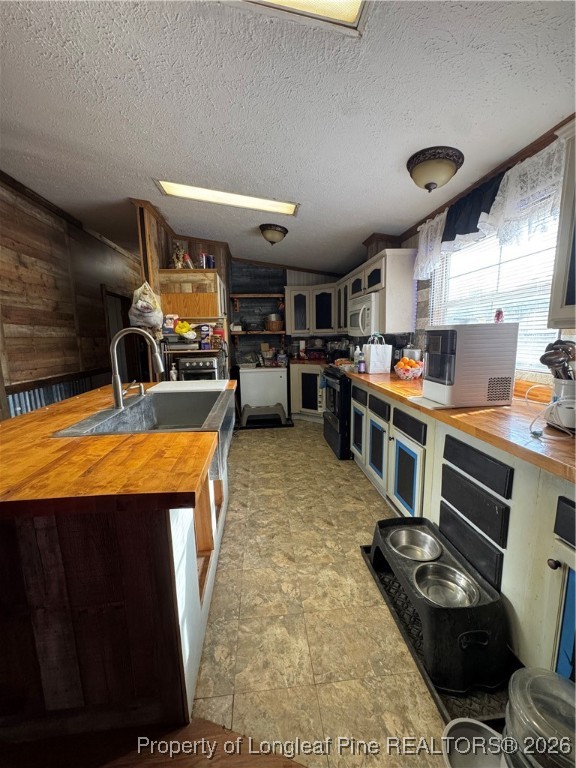 5306 Temperance Hall Road Elm City, NC 27822 - Photo 7 of 22 a kitchen with stainless steel appliances a stove a sink dishwasher and cabinets