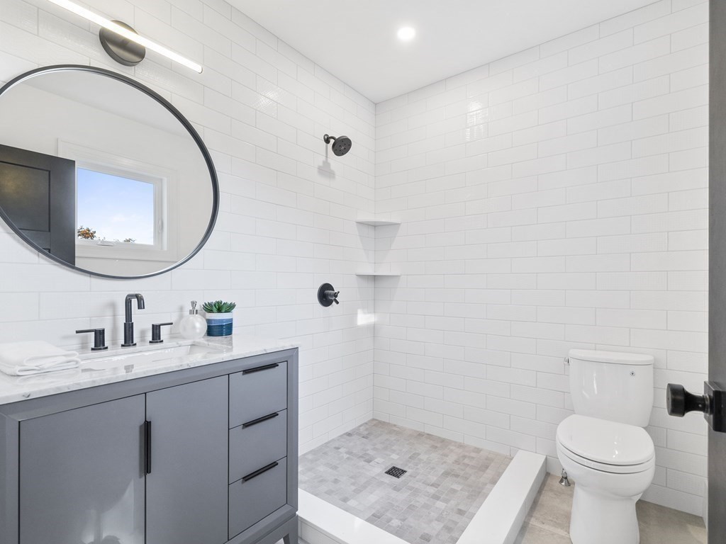 30 Westvale Road Medford, MA 02155 - Photo 12 of 35 a bathroom with a sink a toilet and a mirror