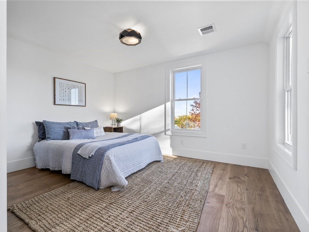 30 Westvale Road Medford, MA 02155 - Photo 13 of 35 a spacious bedroom with a bed and a window