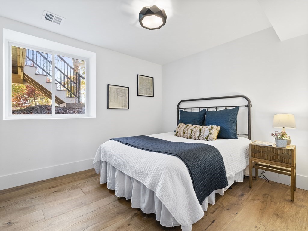 30 Westvale Road Medford, MA 02155 - Photo 24 of 35 a bedroom with a bed and a painting on the wall