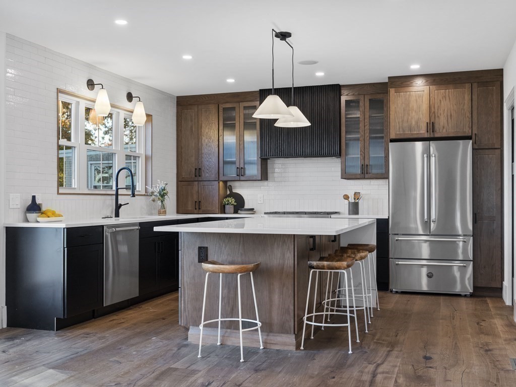 30 Westvale Road Medford, MA 02155 - Photo 7 of 35 a kitchen with a table chairs refrigerator and microwave