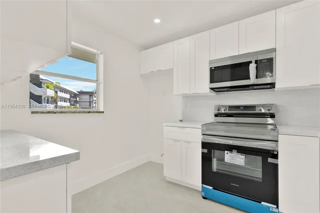 a kitchen with a stove and a microwave