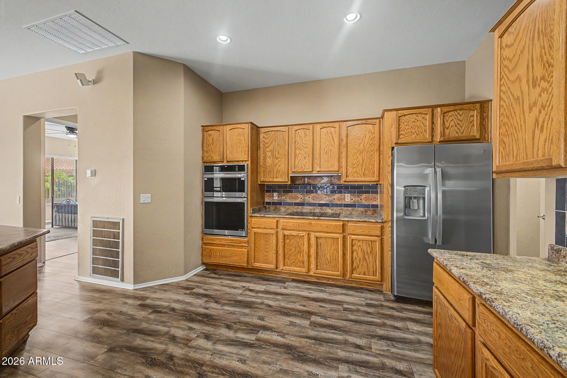 5090 South Ranger Trail Gilbert, AZ 85298 - Photo 10 of 50 a kitchen with stainless steel appliances kitchen island granite countertop a refrigerator and cabinets