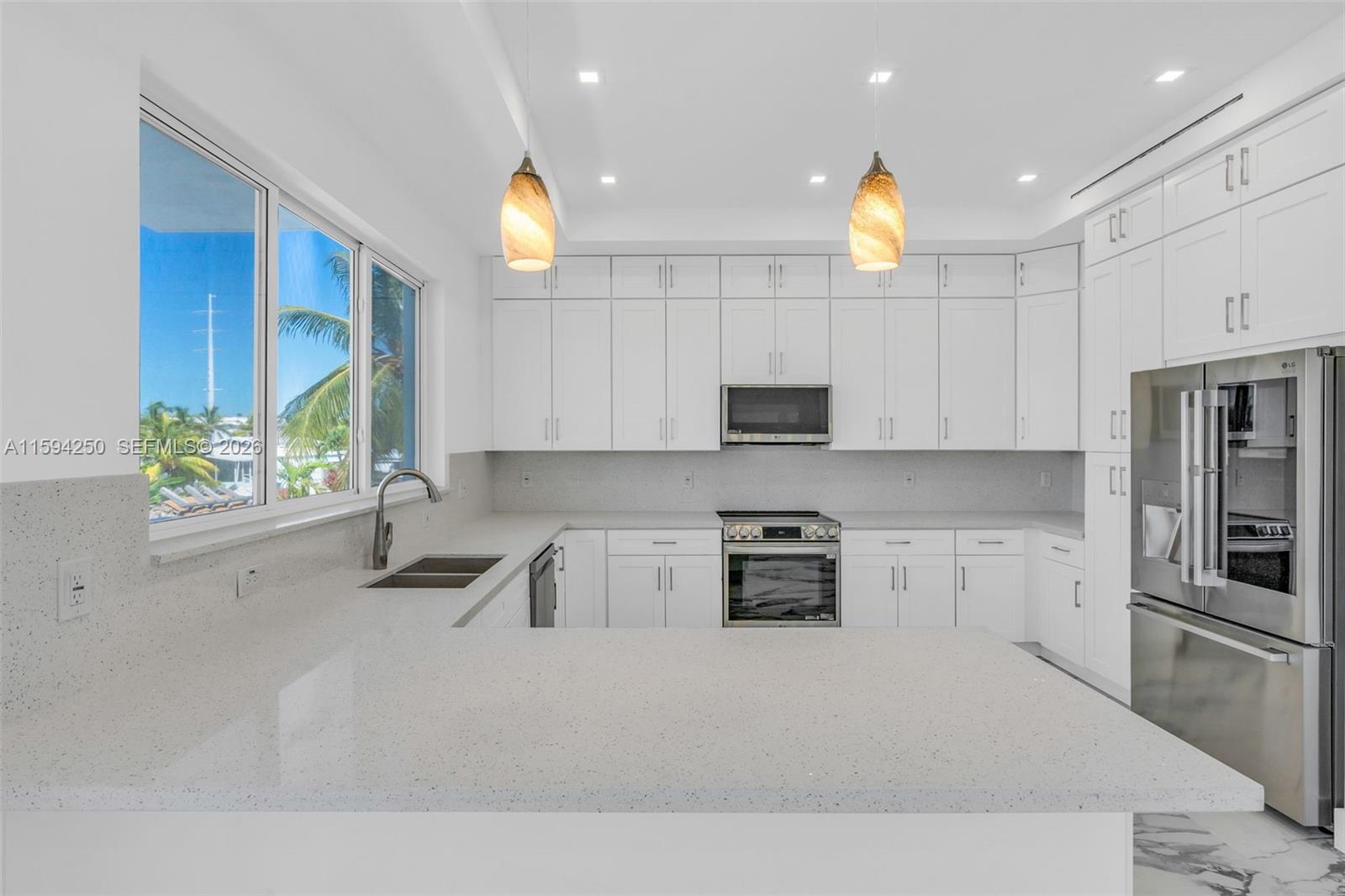 84 Coral Way Key Largo, FL 33037 - Photo 11 of 55 a kitchen with counter top space cabinets and stainless steel appliances