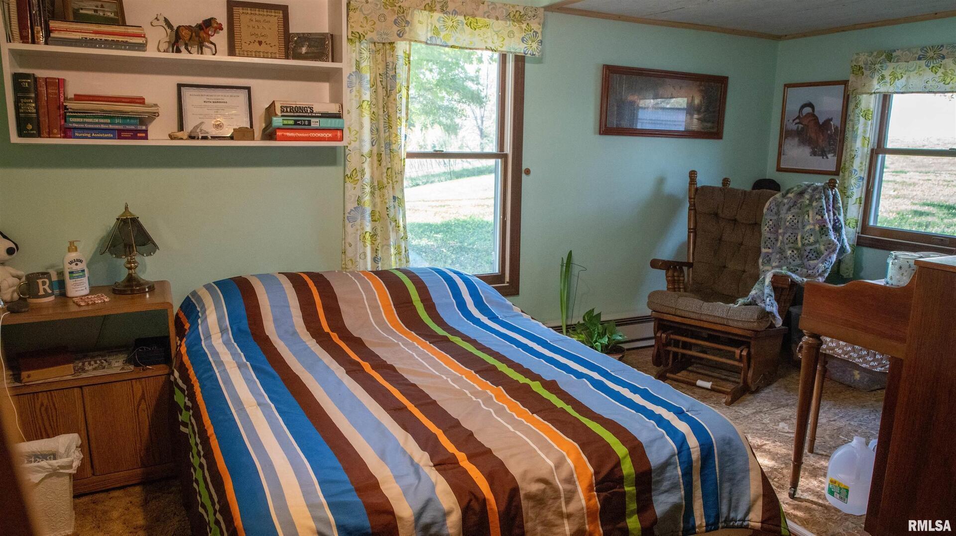 2680 Highway 45 Vienna, IL 62995 - Photo 11 of 20 a bed sitting in a bedroom next to a window