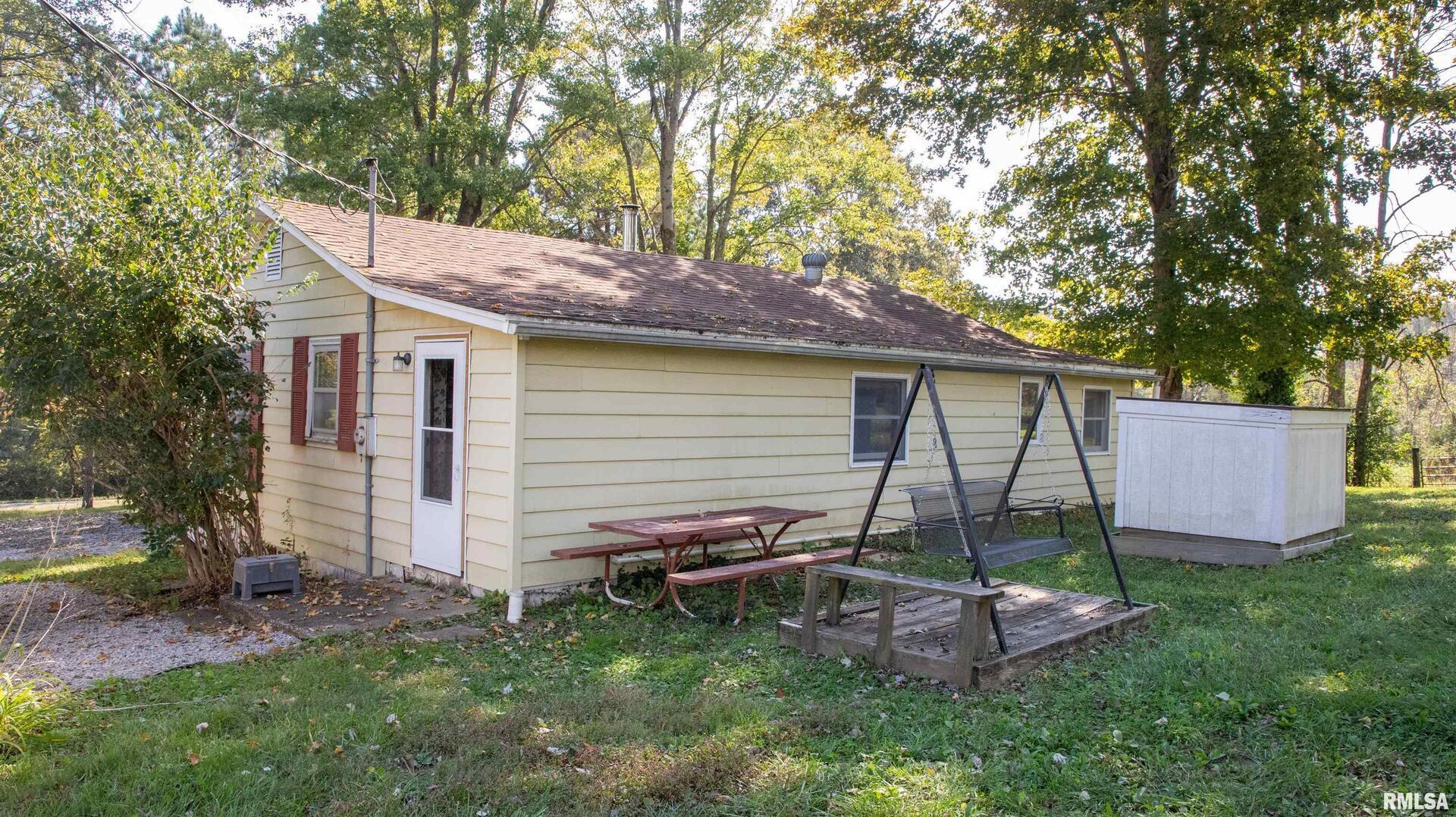 2680 Highway 45 Vienna, IL 62995 - Photo 4 of 20 a backyard of a house with table and chairs