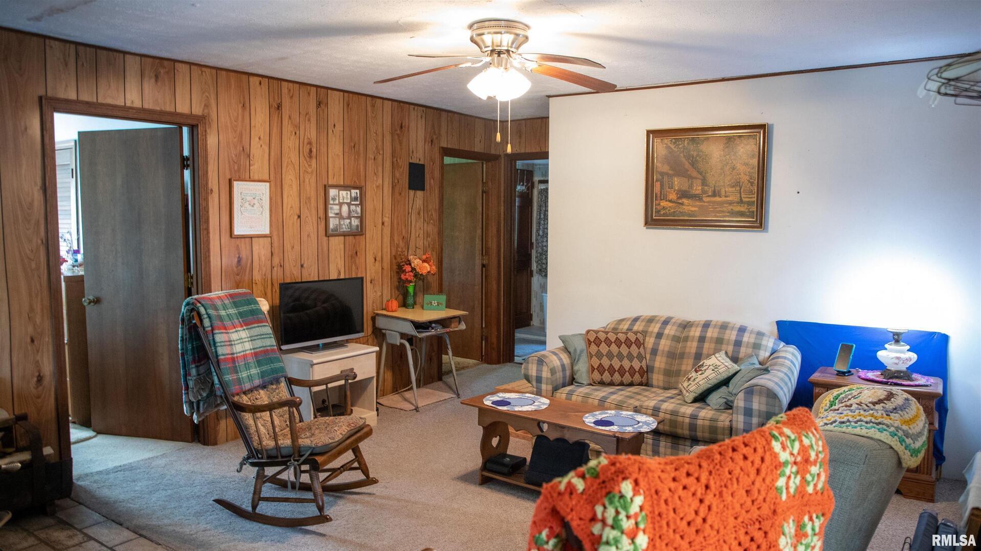 2680 Highway 45 Vienna, IL 62995 - Photo 8 of 20 a living room with furniture a flat screen tv and a window