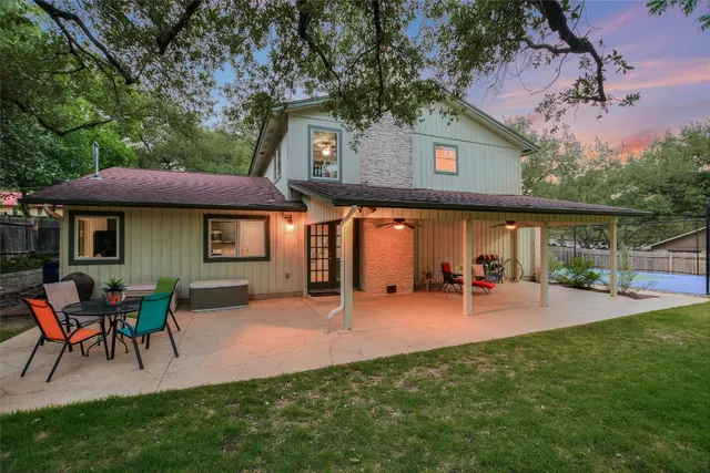 a view of a house with backyard porch and sitting area