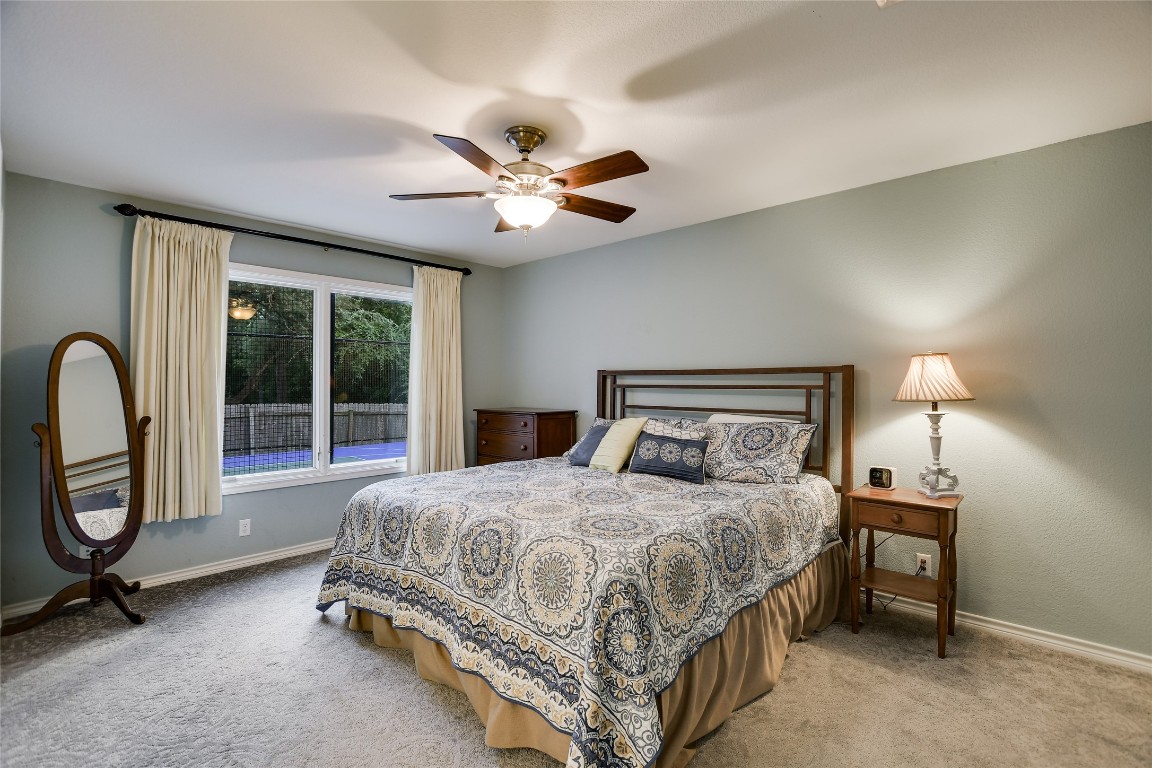 7615 Rockpoint Drive Austin, TX 78731 - Photo 21 of 30 a bedroom with a bed and a chandelier