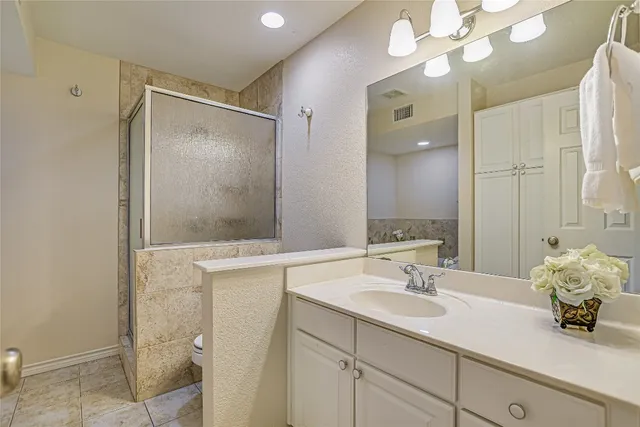 a bathroom with a sink vanity granite and a mirror