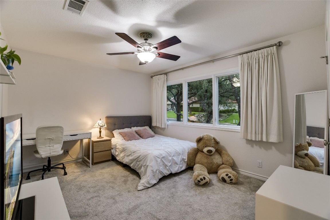 7615 Rockpoint Drive Austin, TX 78731 - Photo 26 of 30 a bedroom with a bed and a chandelier