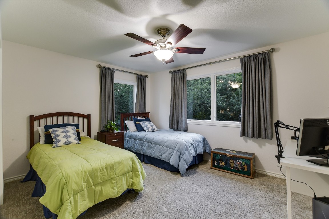 7615 Rockpoint Drive Austin, TX 78731 - Photo 27 of 30 a bedroom with two beds and a chandelier