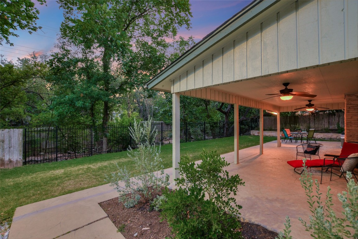 7615 Rockpoint Drive Austin, TX 78731 - Photo 28 of 30 a view of a backyard with table and chairs under an umbrella