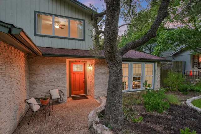 a front view of a house with outdoor seating