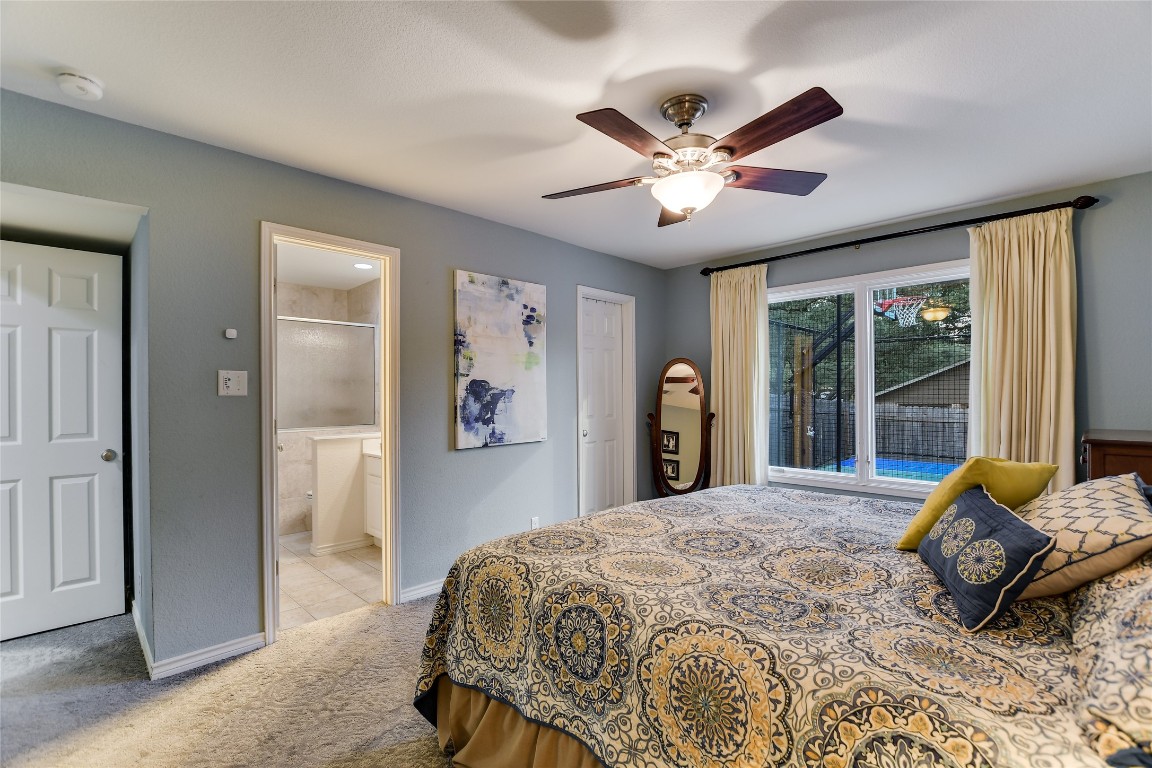 7615 Rockpoint Drive Austin, TX 78731 - Photo 6 of 30 a bedroom with a bed and a large window with a chandelier