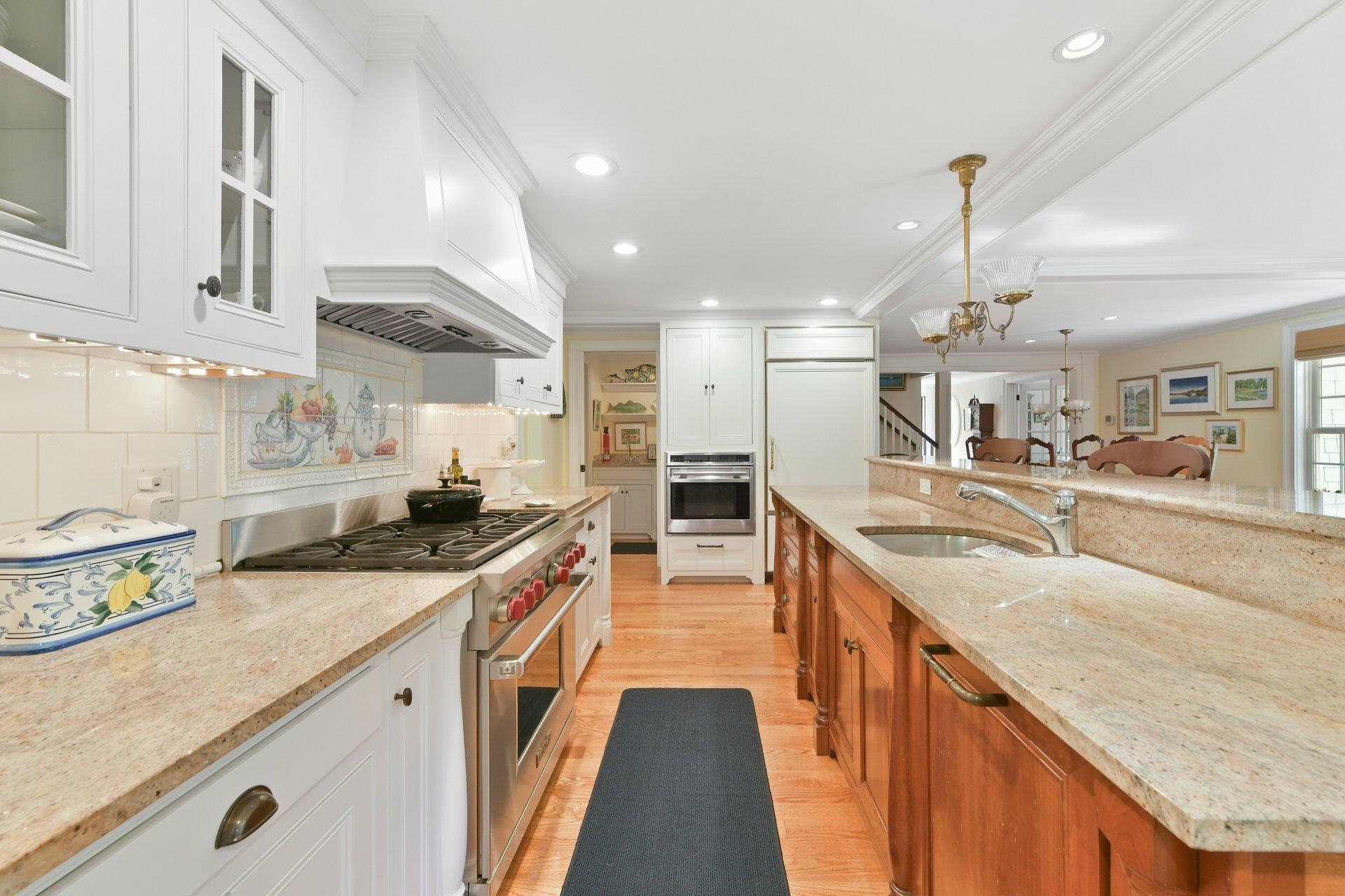 65 Tracey Road Cotuit, MA 02635 - Photo 11 of 36 a large kitchen with stainless steel appliances granite countertop a lot of counter space and a sink