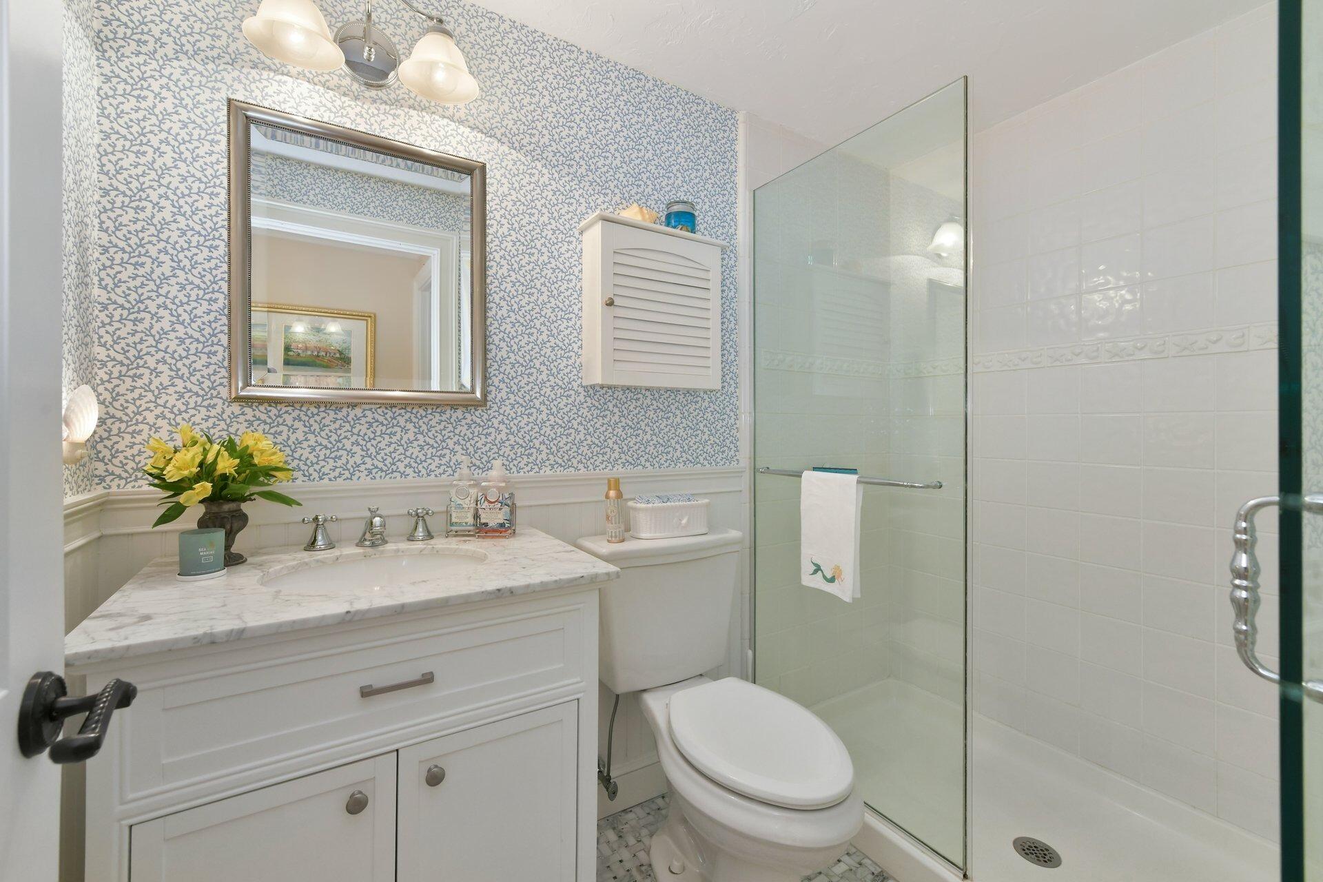 65 Tracey Road Cotuit, MA 02635 - Photo 17 of 36 a bathroom with a granite countertop sink toilet a mirror and shower