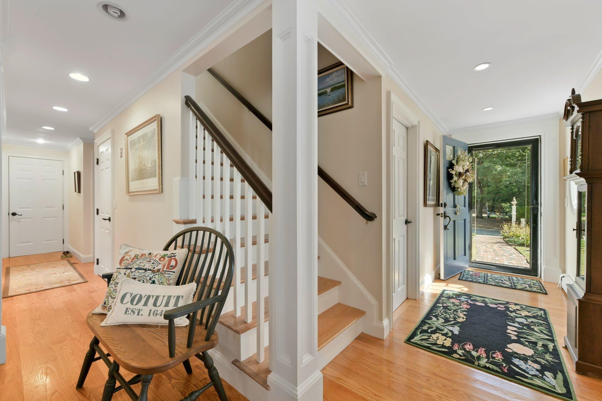 65 Tracey Road Cotuit, MA 02635 - Photo 18 of 36 a view of a hallway with furniture and staircase