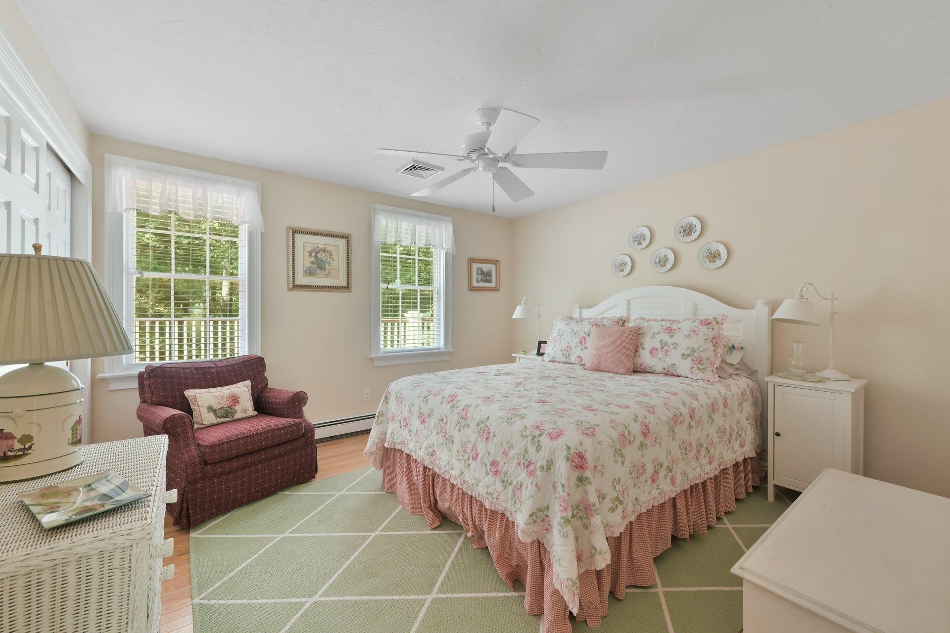 65 Tracey Road Cotuit, MA 02635 - Photo 23 of 36 a bedroom with a bed and a couch