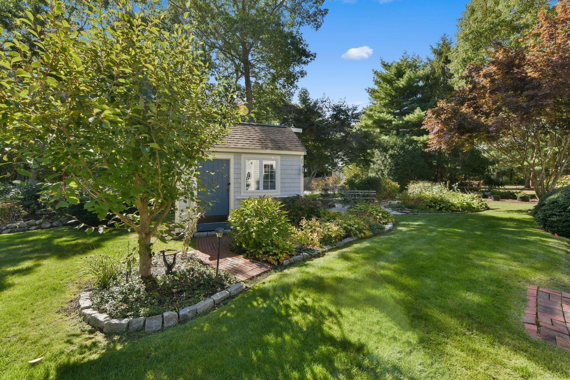 65 Tracey Road Cotuit, MA 02635 - Photo 28 of 36 a front view of a house with garden