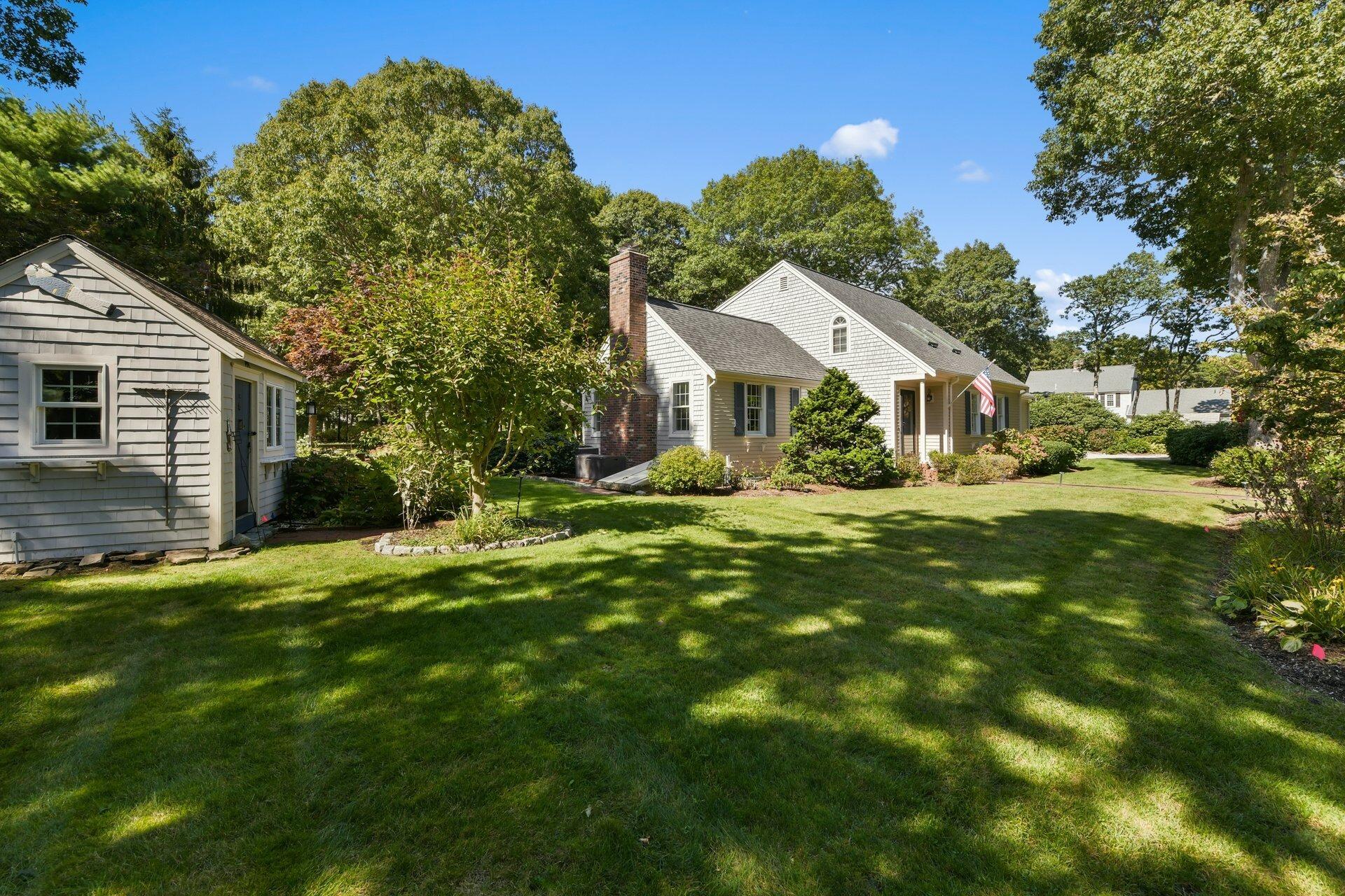 65 Tracey Road Cotuit, MA 02635 - Photo 29 of 36 a front view of a house with a yard