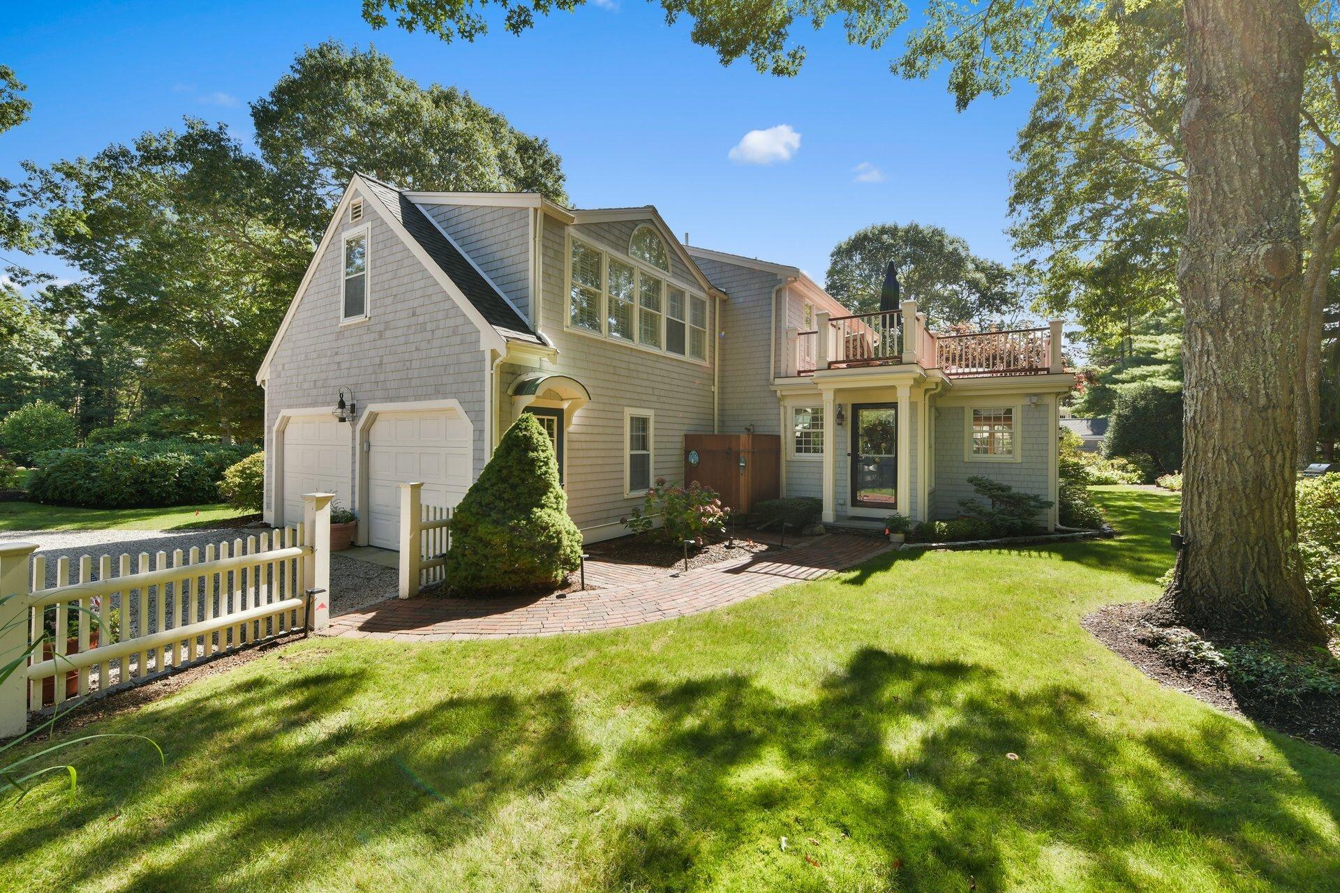 65 Tracey Road Cotuit, MA 02635 - Photo 30 of 36 front view of a house with a yard