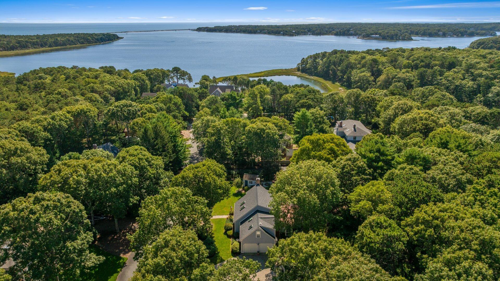 65 Tracey Road Cotuit, MA 02635 - Photo 33 of 36 a view of a lake with a mountain in the background