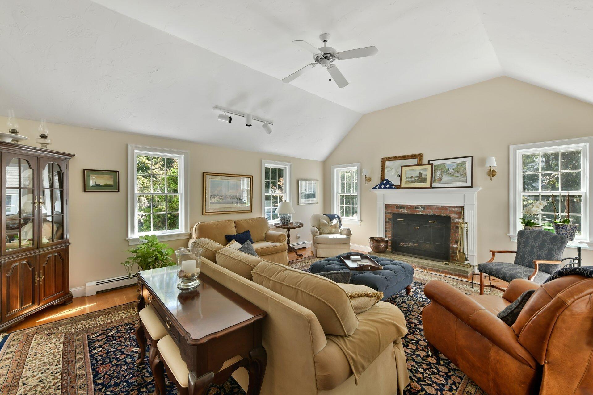 65 Tracey Road Cotuit, MA 02635 - Photo 8 of 36 a living room with furniture large window and a fireplace