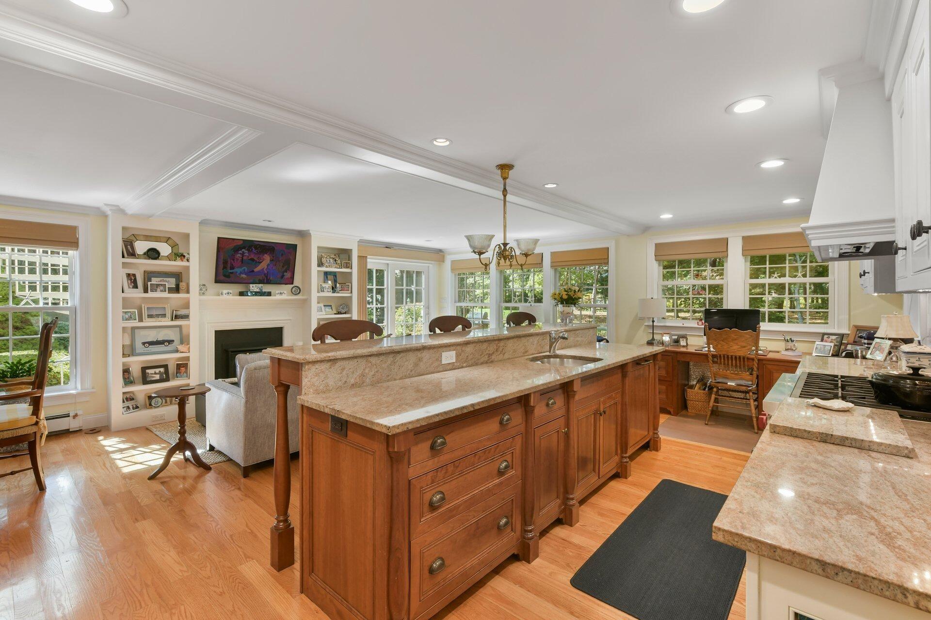 65 Tracey Road Cotuit, MA 02635 - Photo 9 of 36 a open kitchen with stainless steel appliances granite countertop a lot of counter space and wooden floors