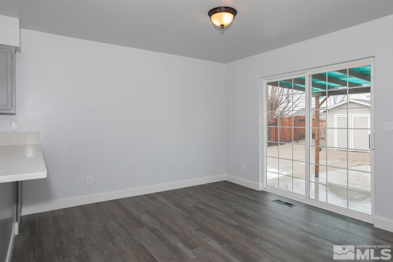 1220 Lattin Road Fallon, NV 89406 - Photo 5 of 25 an empty room with wooden floor and windows