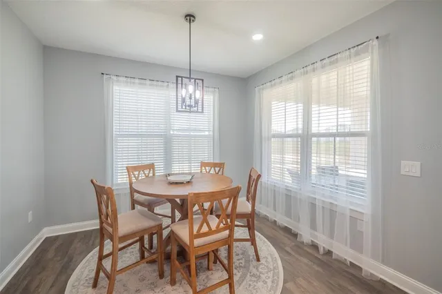 a kitchen with white cabinets and sink