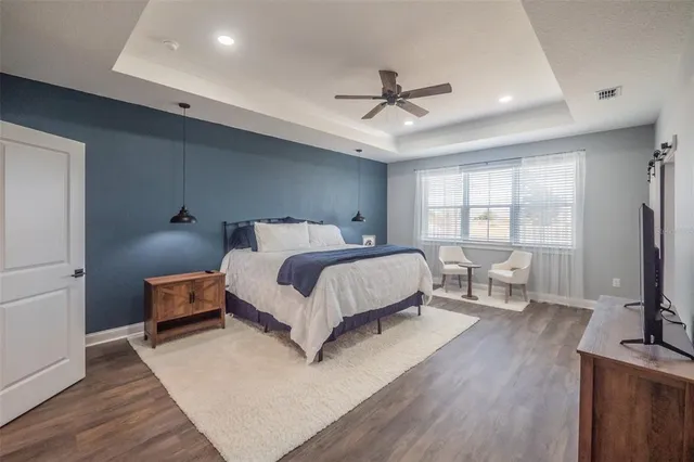 a bedroom with a bed and a tv on the dresser