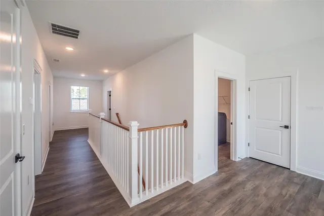 a view of an empty room and wooden floor
