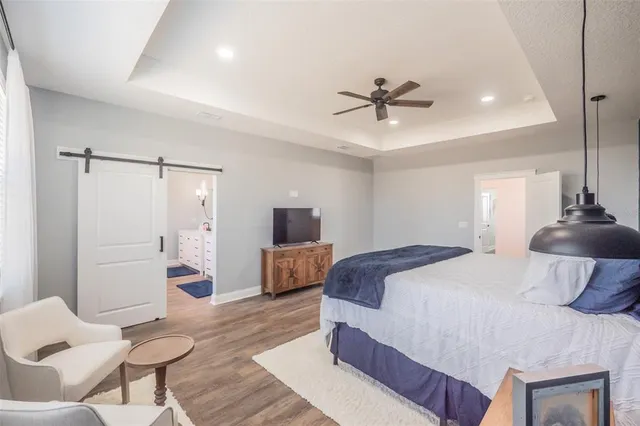 a view of a hallway with wooden floor cabinet and a mirror