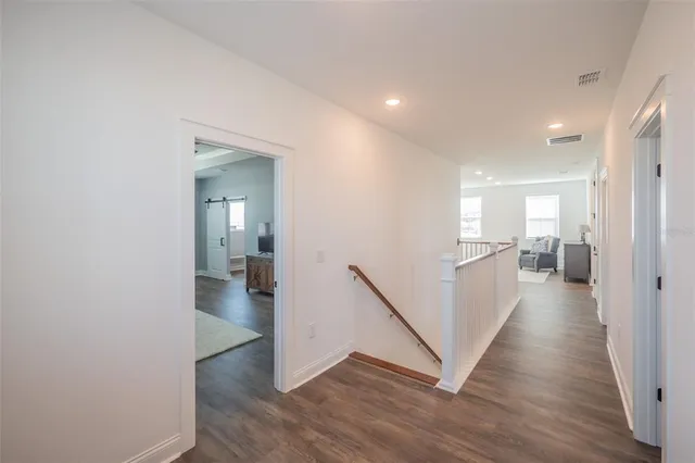 a front view of a house with a garden and plants
